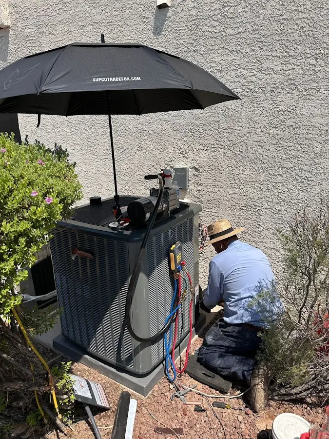 HVAC technician performing outdoor AC maintenance in Odenville